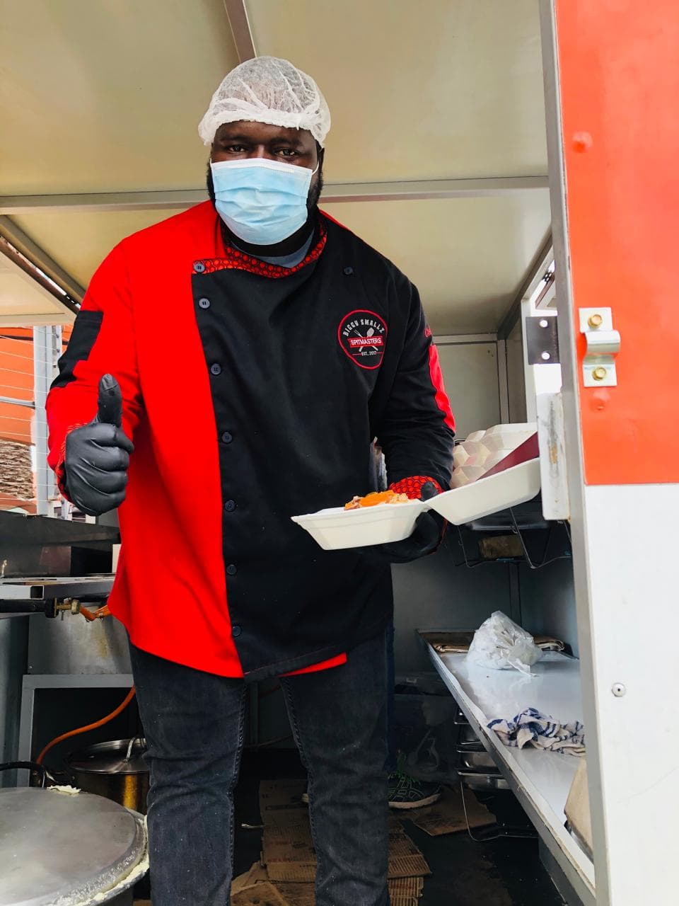 Biggy holding a packed hot meal, ready to hand out.