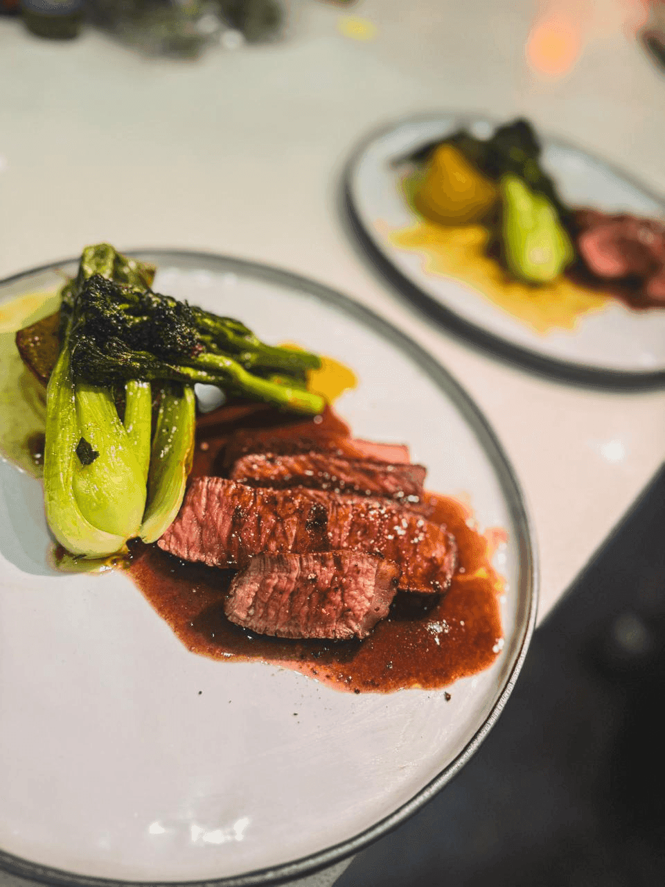 Reverse-seared rib eye with fondant potato, broccolini and bok choy.