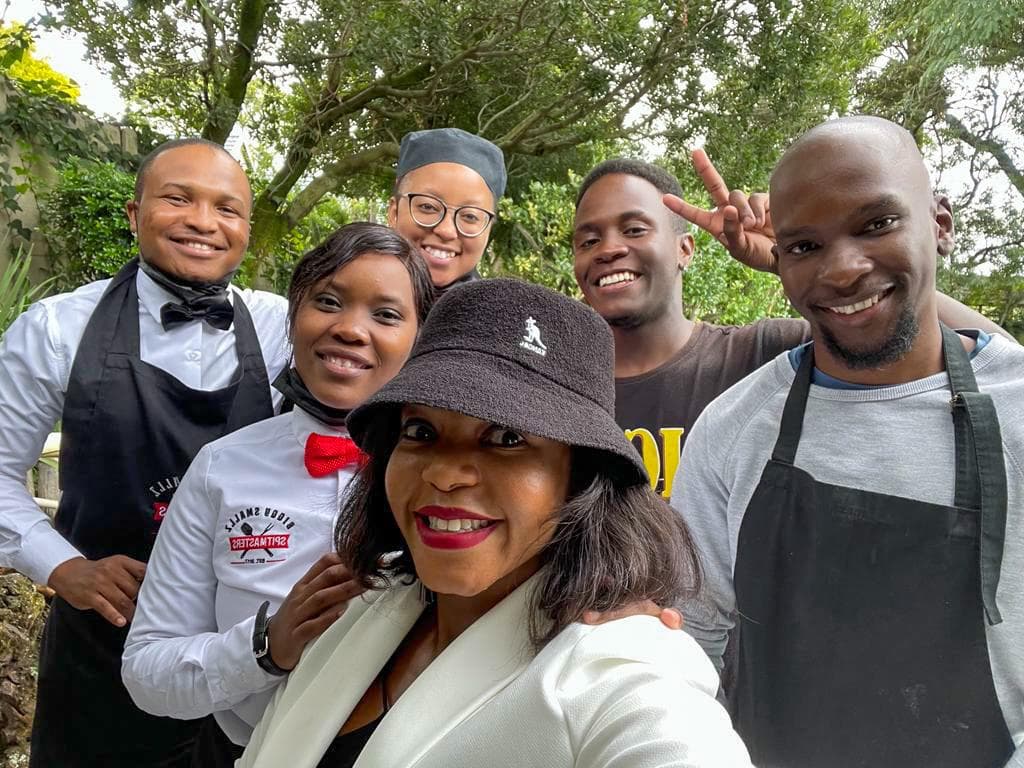 Kitchen and front-of-house staff together outside a wedding venue.