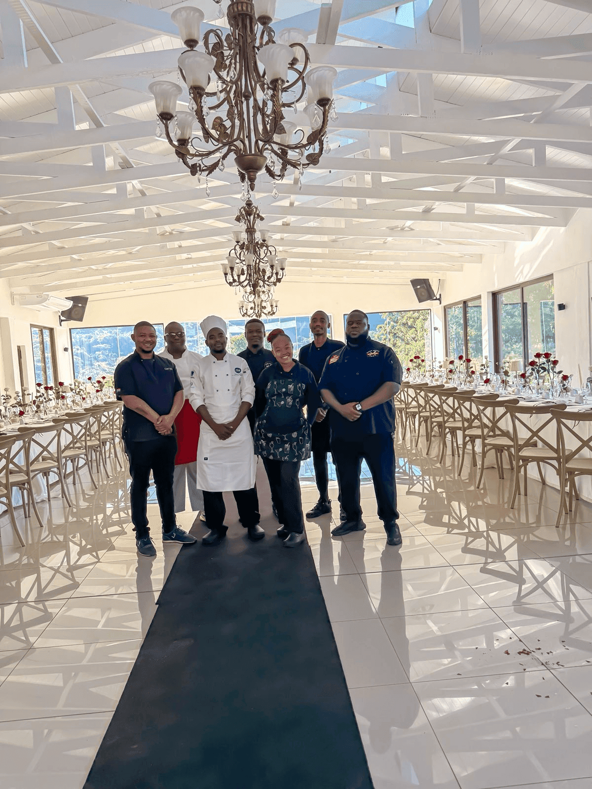 The Biggy Smallz Spitmasters team lined up in the hall at Moyres Venue, tables laid behind them.