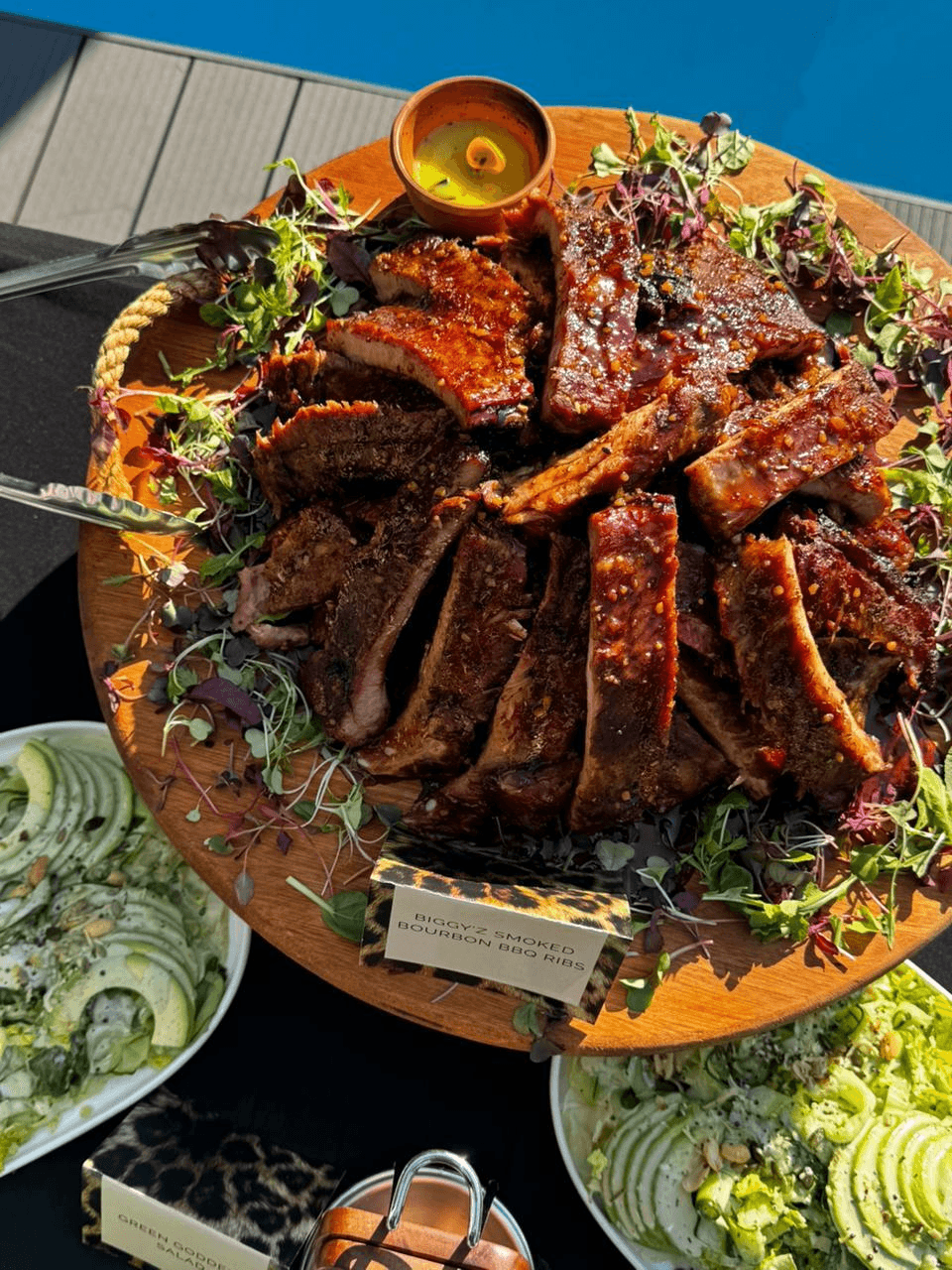 Smoked bourbon BBQ pork ribs on a board.