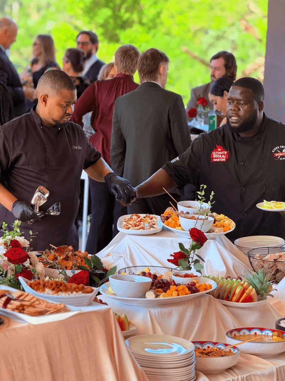 Biggy and Chef Sikolethu plating together at the table.